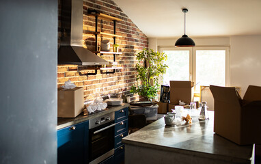 Interior of empty home kitchen with moving boxes - obrazy, fototapety, plakaty
