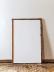 photo of a large blank frame leaning against a white wall. art mockup