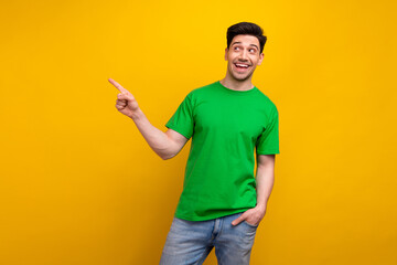 Photo of excited smiling funny guy point finger empty space recommend new web design studio ad...
