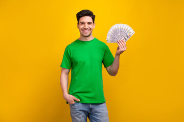 Photo portrait of handsome young brunet guy hold money dollars fan wear trendy green outfit...