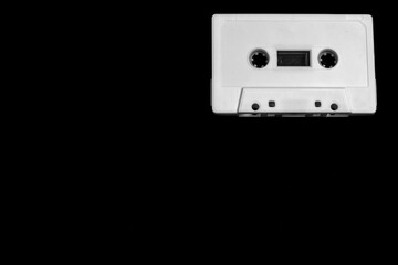 white cassette on black background with copy space