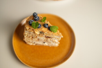 Homemade baked cake Napoleon, Millefeuille. Delicate custard cake garnished with berries and mint....