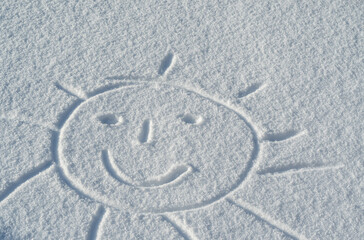 Fototapeta na wymiar hand drawn a smiley sun in snow