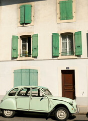 Retro french feeling with an old French car in Carouge district of Geneva. Green car and green window shutter fits well.