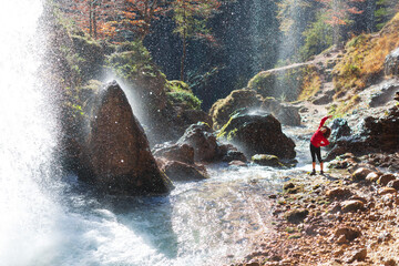 Mid Adult Woman Trekker Stretching Exercises Near a Beautiful  Waterfall Environment