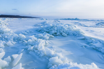Landscape with frozen Baltic Sea on a sunny winter day. Ice hummocks