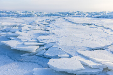 Fototapeta na wymiar Broken ice shards lay on the coast of Baltic Sea