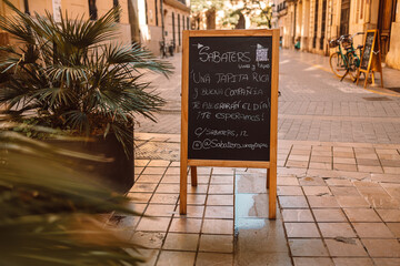 Restaurant sidewalk chalkboard sign board with coffee menu. Black board at a restaurant. High...