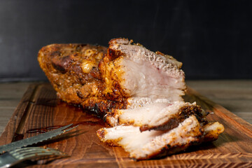 baked pork belly on a wooden board. food concept. diet. meat