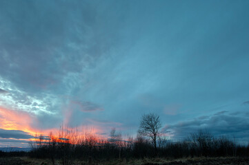 Summer sunset over wheat field. Beautiful sunset sky over countryside