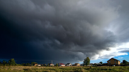 Amazing dark stormy tornado clouds over the city. - obrazy, fototapety, plakaty