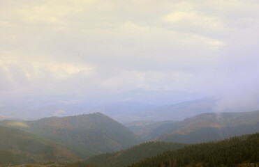 Morning view from the Dragobrat mountain peaks in Carpathian mountains, Ukraine. Cloudy and foggy...