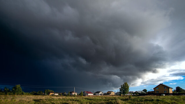 Amazing dark stormy tornado clouds over the city.