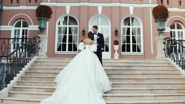 Lovely caucasian bride embracing groom. Happy wedding couple family. Romantic love of man hugging woman. Bride in wedding dress.