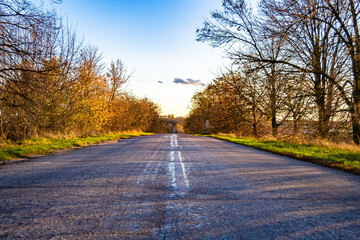Fototapeta premium Beautiful empty asphalt road in countryside on colored background