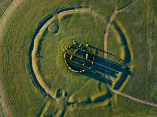 Aerial shot looking down on Stonehenge in low sun with long shadows