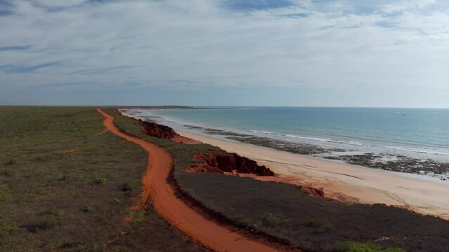 Aerial view of a long coastline with red rock formation and beach at James Price Point Broome, Western Australia, Australia.