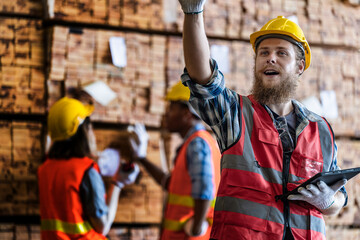 workers man and woman engineering walking and inspecting with working suite dress and hand glove in the front machine. Concept of smart industry worker operating. Wood factories produce wood timber.