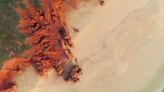 Aerial view of a long coastline with red rock formation and beach at James Price Point Broome, Western Australia, Australia.