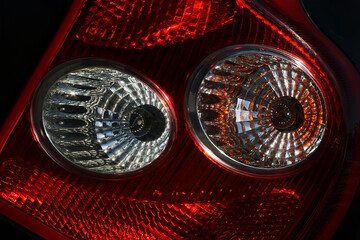 Abstract red car lights. Close-up of automotive illuminated glowing lights in motion, background.