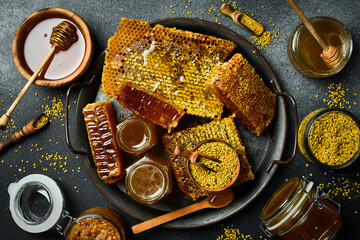 Honey background. A large set of honey, bee combs, flower pollen. Beekeeping products. Top view. - obrazy, fototapety, plakaty