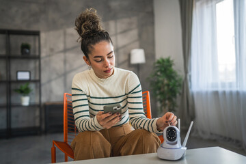 adult caucasian woman set up prepare home surveillance security camera