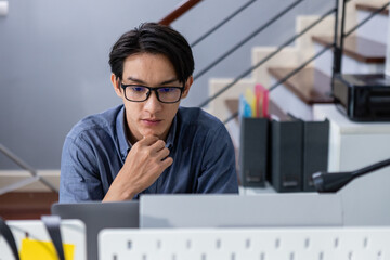 ํYoung man committed working look at computer. Male office worker, Working on analyzing...