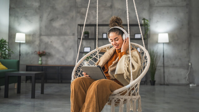 Woman sit at home use digital tablet to watch movie or have video call