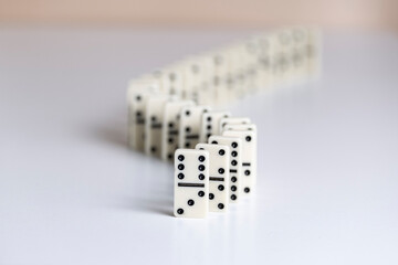 Falling dominoes, domino effect. The bones fall one after the other. The concept of related...
