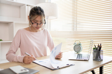 Businesswoman analyzes data graphs and works intently in his personal office, Employees working in...