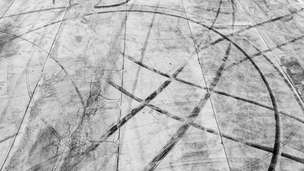 Tire track mark on asphalt tarmac road race track texture and background, Abstract background black tire tracks skid on asphalt road in racing circuit, Tire mark skid mark on asphalt road.
