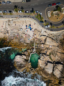Aerial view of swimmers and beach goers at Saunder&rsquo;s Rock tidal pool in summer in Bantry Bay, Atlantic Seaboard, Cape Town, South Africa.
