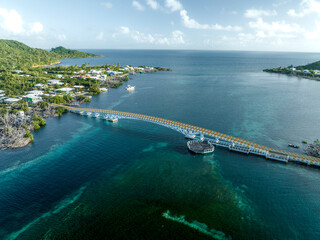 Aerial view of a suspended bridge crossing the bay connecting the two islands Providencia and Santa Catalina Island, Archipelago of Saint Andrew, Colombia.