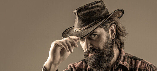 American cowboy. Leather. Cowboy Hat. Portrait of young man wearing cowboy hat. Cowboys in hat. Handsome bearded macho