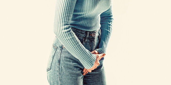 Closeup woman hands holding her crotch. Woman hands holding her crotch. Sick woman hands holding pressing her crotch lower abdomen