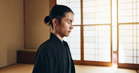 Martial arts man, meditation and training in Japanese dojo with mindfulness, zen or chakra balance...