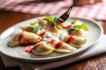 Eastern European traditional food dumplings - pierogi, varenyky, pirohy filled with strawberries...