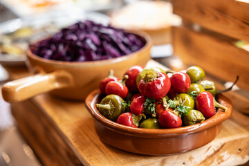 Canned hot peppers in a bowl on a restaurant buffet table