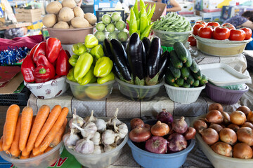 Closeup of market stall selling fresh assortment of vegetables from local ecological producers in bazaar - obrazy, fototapety, plakaty