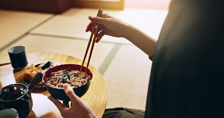 Closeup of bowl of noodles, hands and man is eating food, nutrition and sushi with chopsticks in...