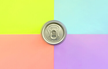 Tin aluminum silver beer can on a pastel background. Minimal flat lay top view. Living coral, violet, blue and yellow colors