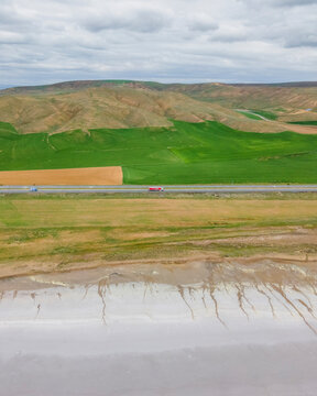 Aerial view of a road driving along the Tuz Golu (Lake Tuz), one of the largest hyper saline lake in the world, Central Anatolia Region, Turkey.