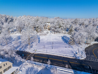 Weston Town Hall aerial view at Lanson Park in winter in historic town center of Weston, Massachusetts MA, USA.  