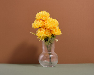Yellow bright spring flowers in a vase. A romantic surprise and gift.