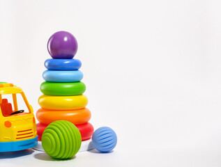 Toys for kids and play time. Pyramid with colored rings and purple ball on top, bright baby car...