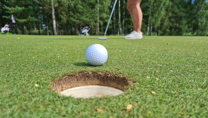 Golf ball with a club on green field in hall