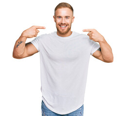 Young irish man wearing casual clothes smiling cheerful showing and pointing with fingers teeth and mouth. dental health concept.
