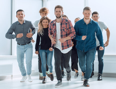 group of diverse young people running forward