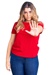 Young caucasian woman wearing casual clothes doing stop sing with palm of the hand. warning expression with negative and serious gesture on the face.