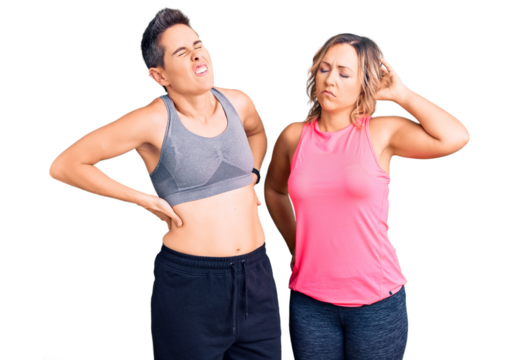 Couple of women wearing sportswear suffering of neck ache injury, touching neck with hand, muscular pain